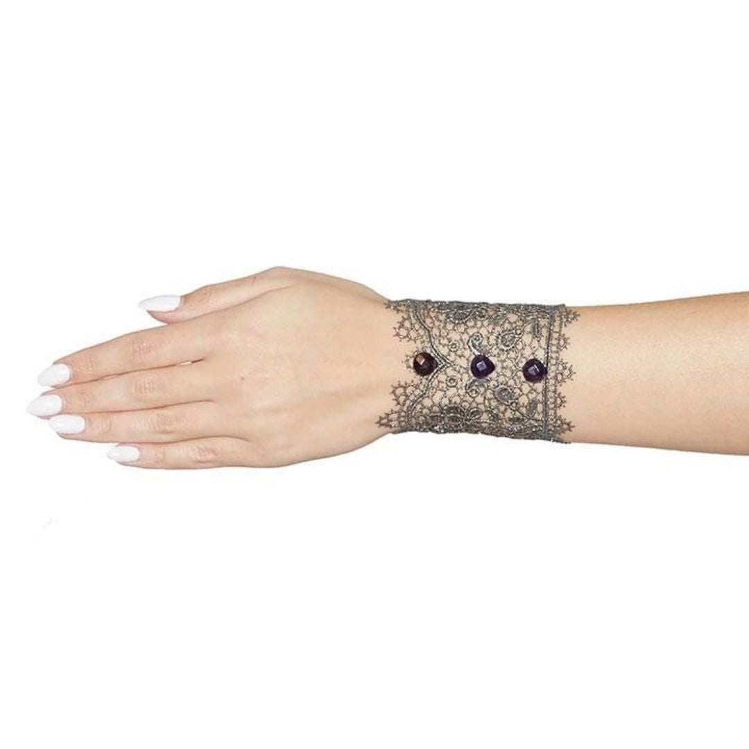 Bronze lace cuff bracelet with purple gems on arm